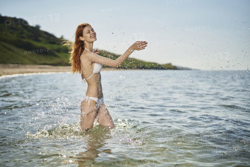 Caucasian woman splashing in ocean