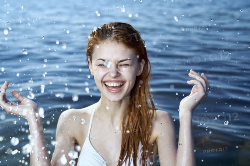 Caucasian woman splashing in ocean