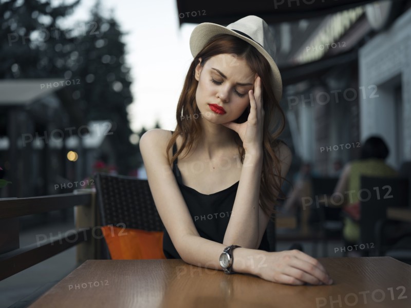 Frustrated Caucasian woman at sidewalk cafe