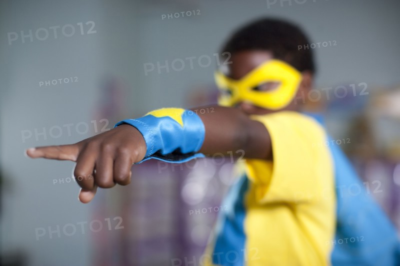 African American boy playing in superhero costume