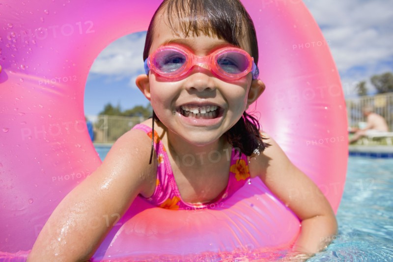 Portrait of girl in swimming pool wearing goggles