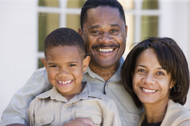African American family smiling outdoors