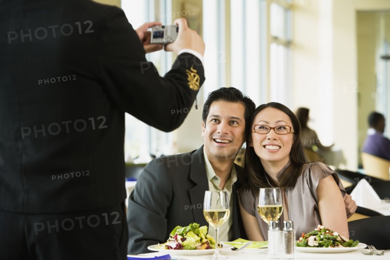 Couple having photograph taken at restaurant