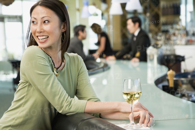 Woman at bar with glass of wine