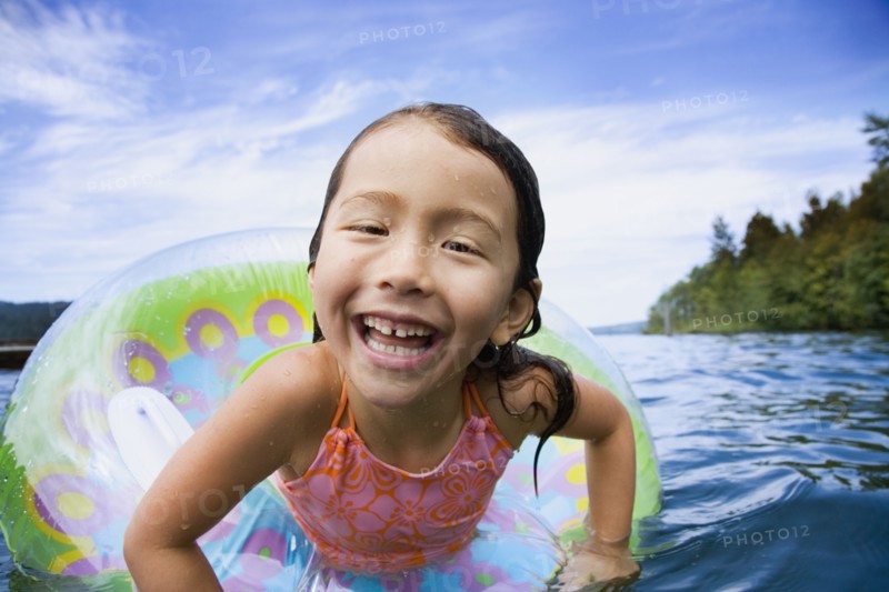 Asian girl swimming with inner tube