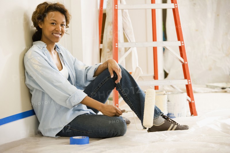 African woman taking break from painting