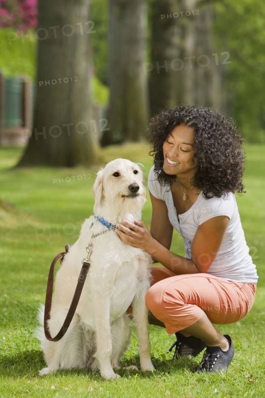 African American woman petting dog
