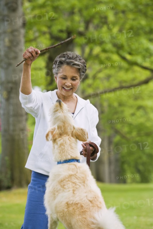 African American woman playing with dog
