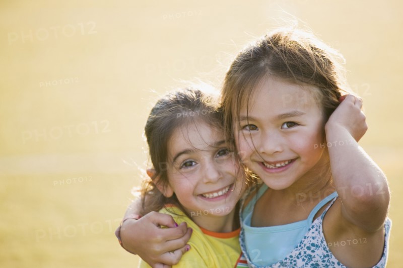 Smiling friends hugging