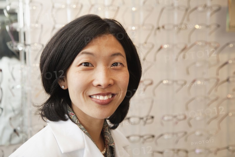 Korean optician standing in store