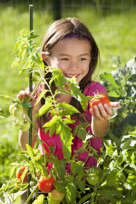 Mixed race girl gardening