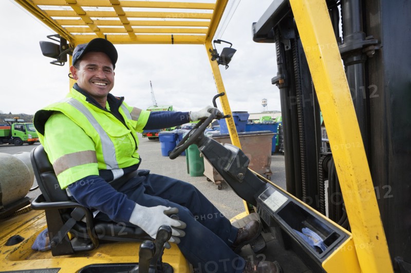 Hispanic man driving forklift