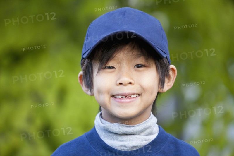 Smiling Korean boy in baseball cap