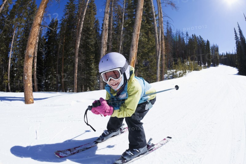 Mixed race girl skiing downhill