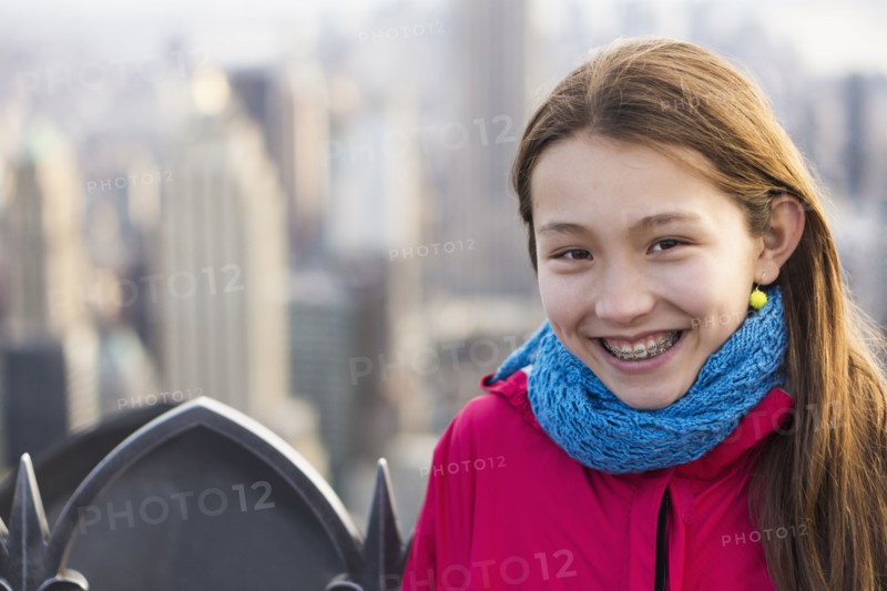 Mixed race girl smiling on urban rooftop