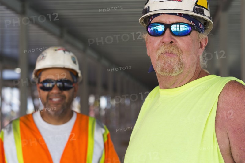Workers smiling together at construction site