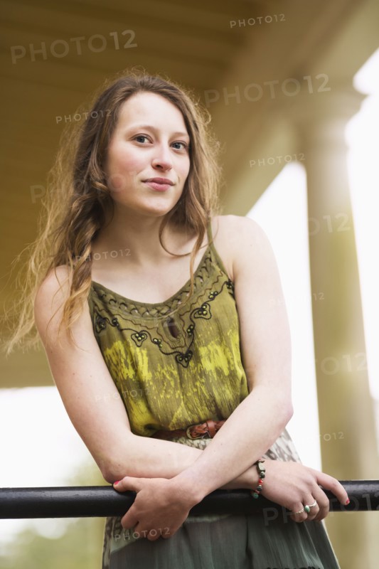 Caucasian teenage girl leaning on banister