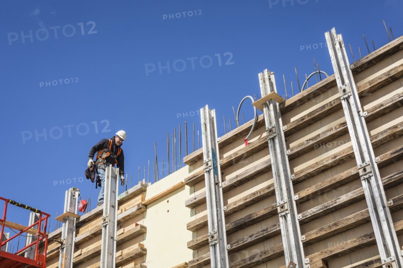 Caucasian worker walking on concrete wall form