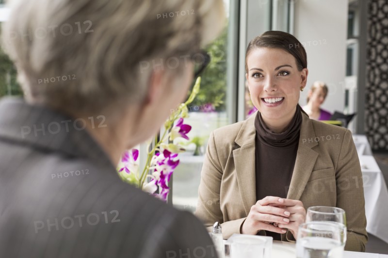 Caucasian businesswomen talking in restaurant