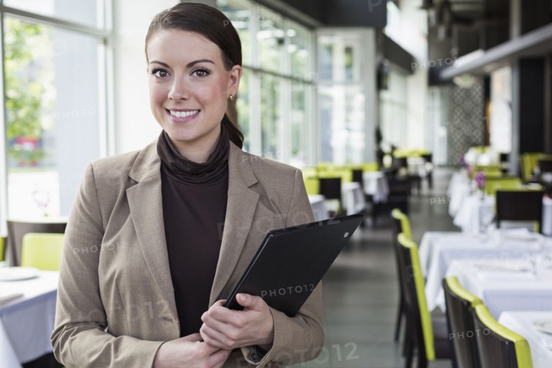 Caucasian businesswoman standing in restaurant
