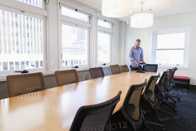 Businessman standing at table in conference room