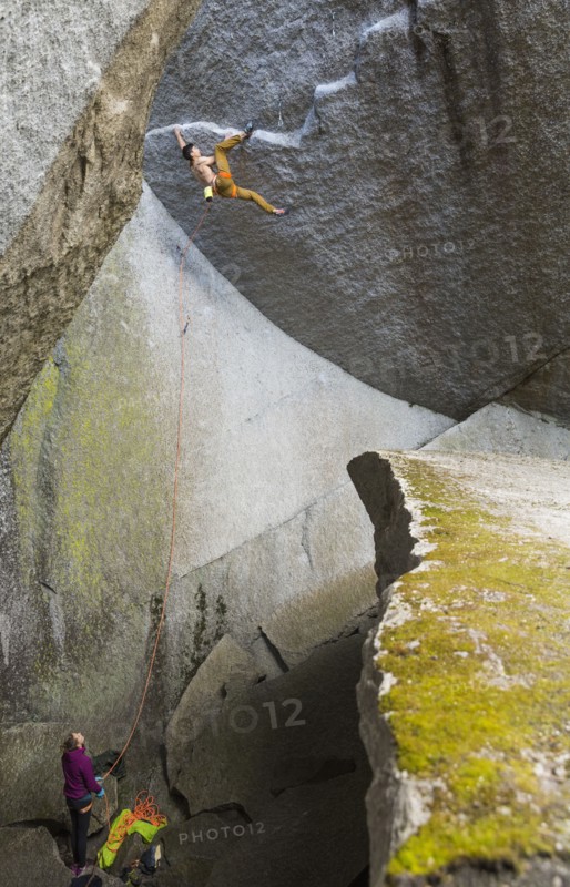 Girl watching boy rock climbing
