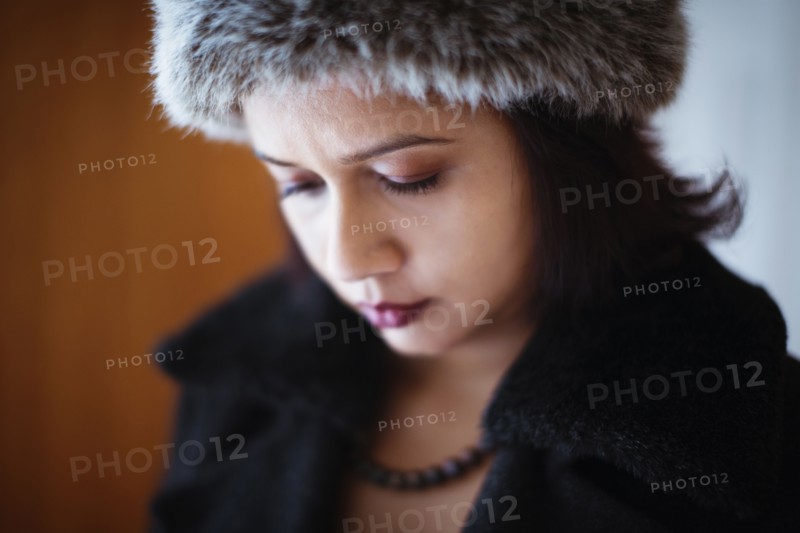 Mixed race woman wearing furry hat and coat