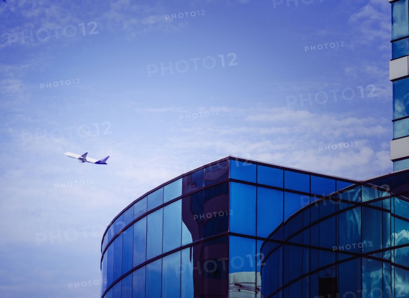 Airplane flying over airport tower