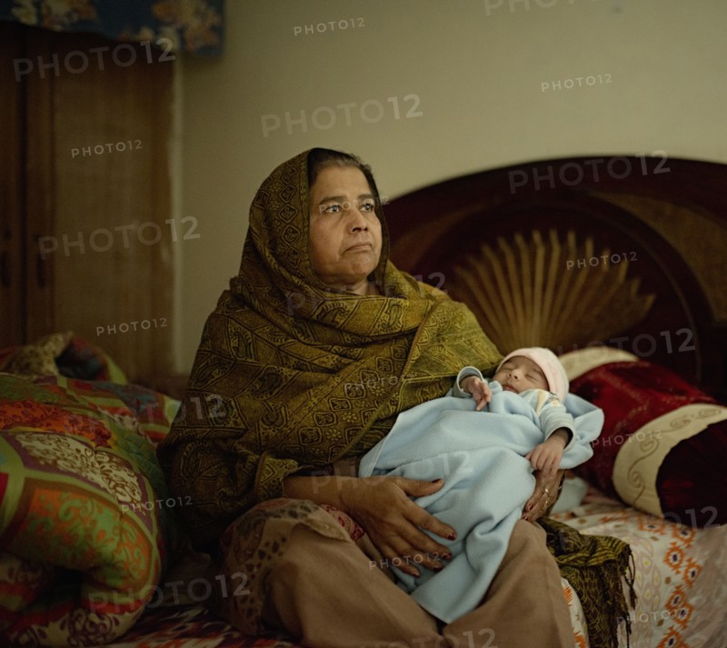 Grandmother holding baby grandson