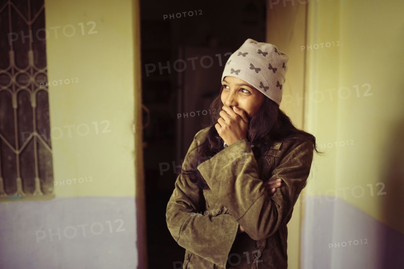 Laughing woman covering her mouth