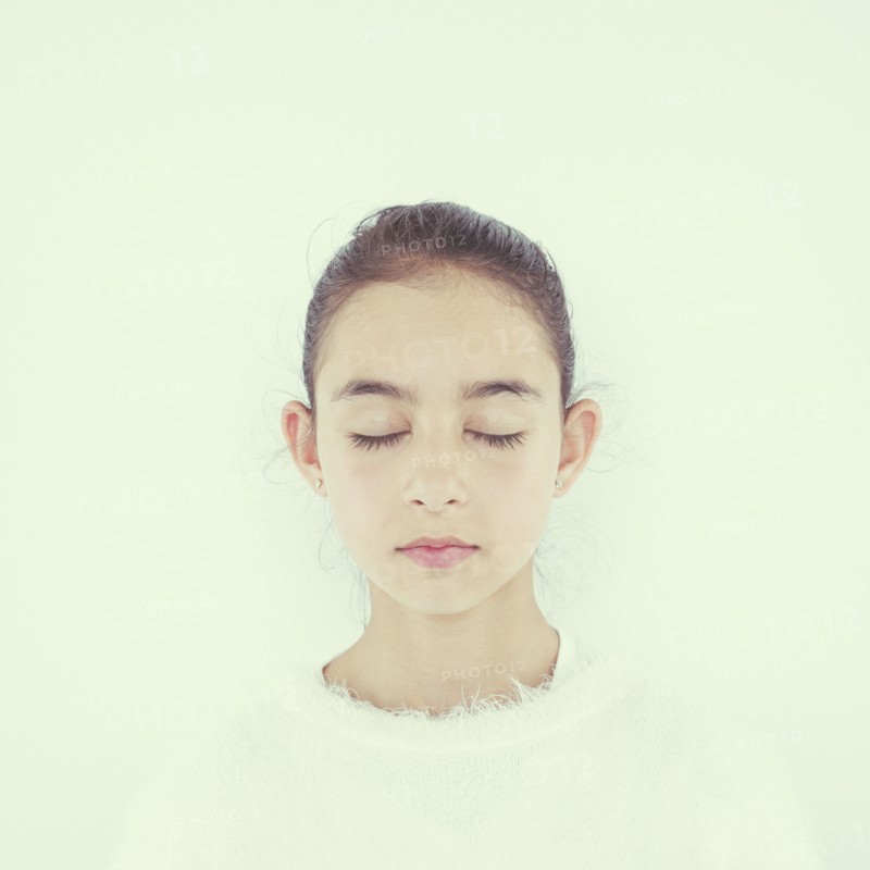 Close up of mixed race girl with eyes closed