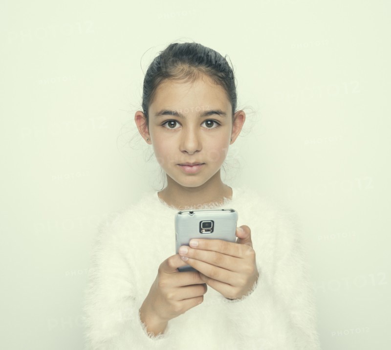 Mixed race girl using cell phone