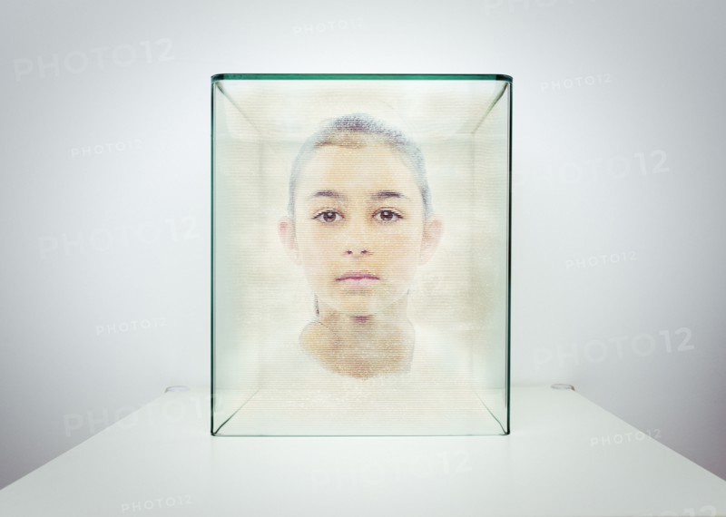Hologram of Mixed race girl in glass box
