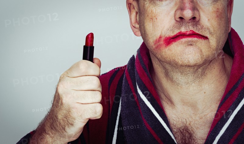 Caucasian man wearing smeared lipstick
