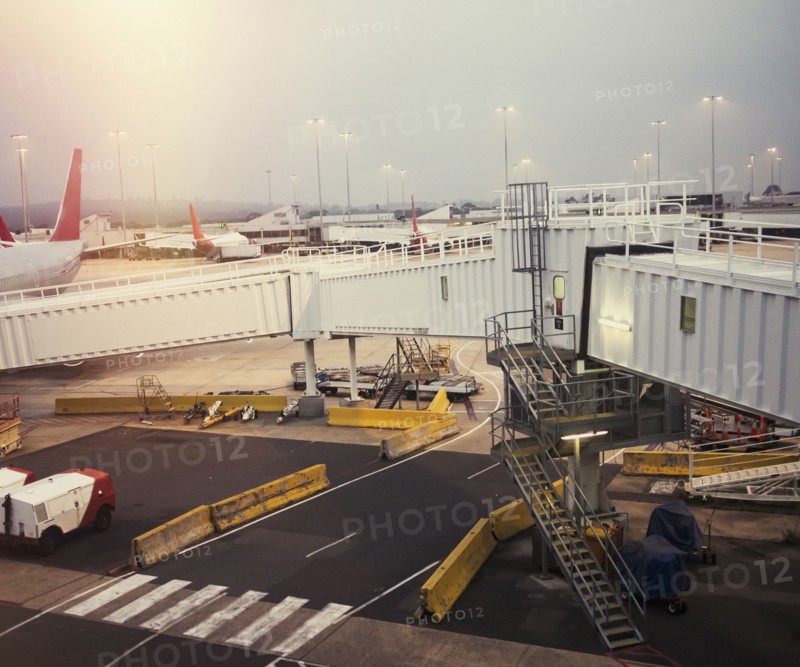 Airplane and elevated walkway on airport runway