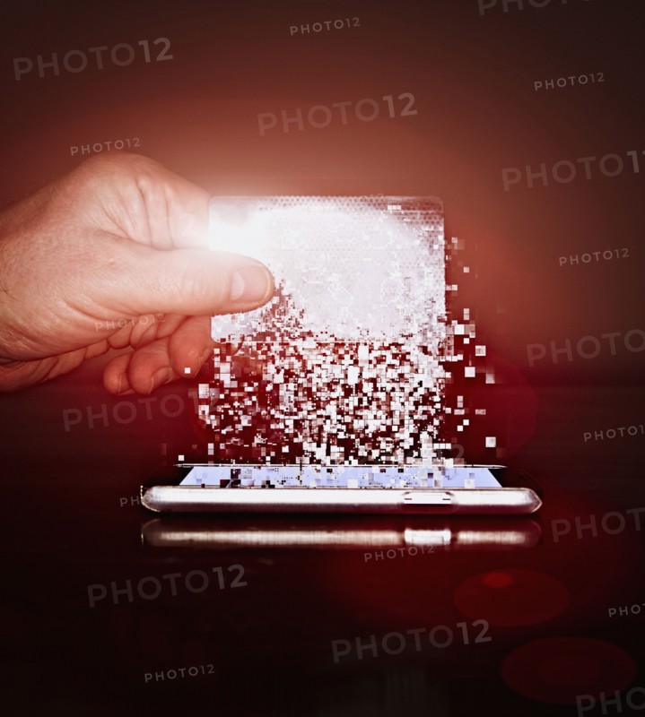 Caucasian man holding pixelated credit card