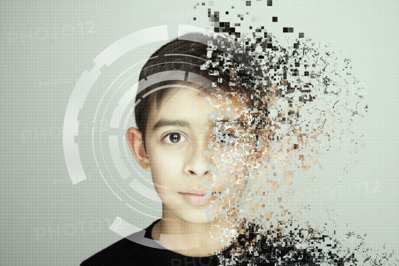 Pixelated mixed race boy looking at camera