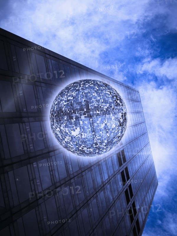 Low angle view of orb floating near highrise building