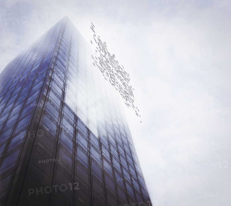 Pixelated highrise building and cloudy sky