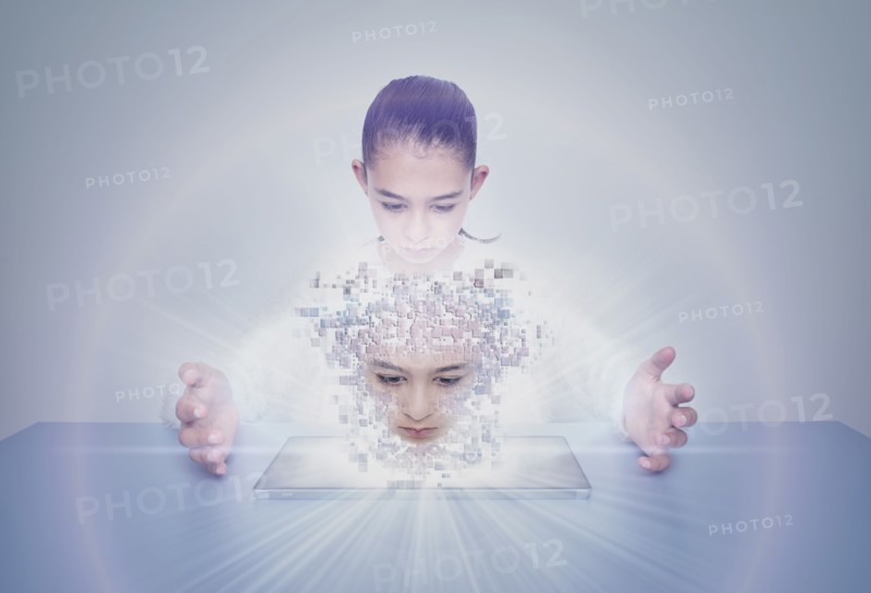 Mixed race girl with digital projection of face