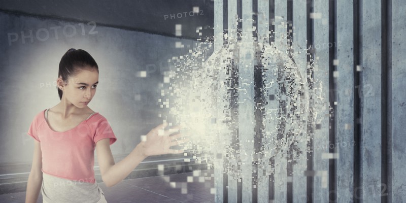 Mixed race girl touching pixelated sphere