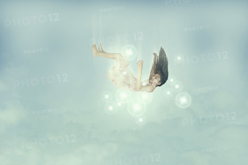 Mixed race girl falling in sky