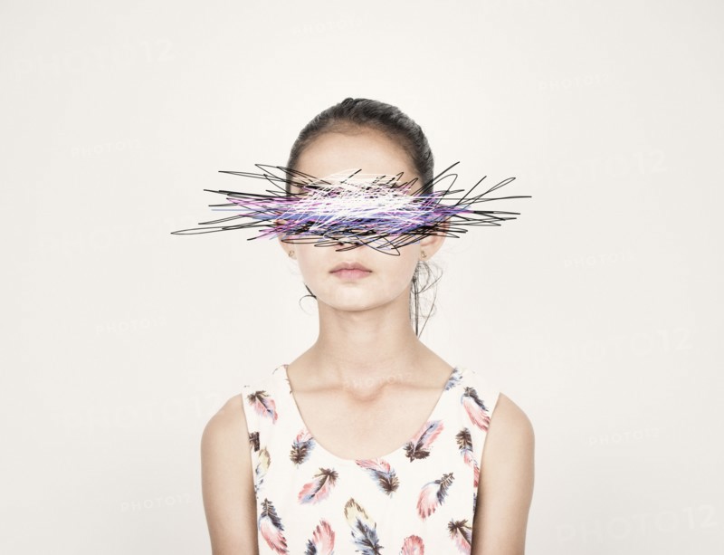 Mixed race girl with eyes scribbled out