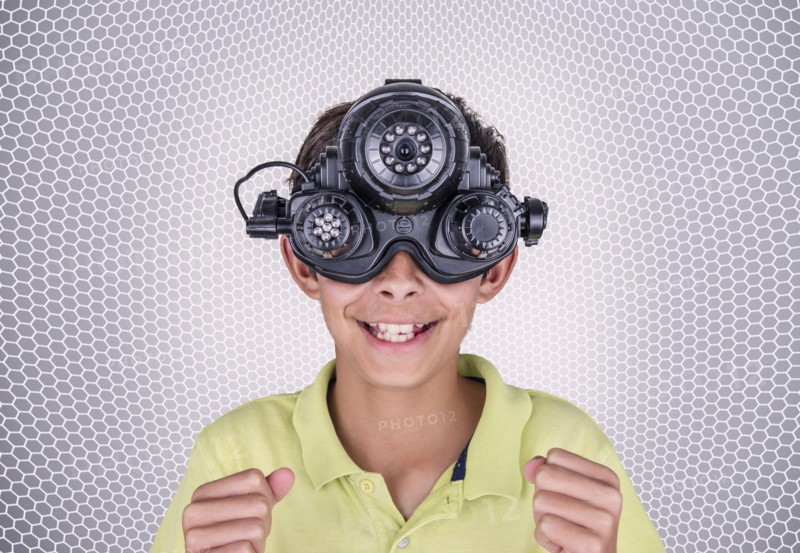 Mixed race boy wearing virtual reality goggles