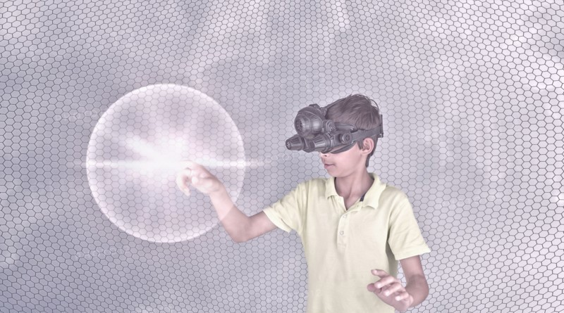 Mixed race boy wearing virtual reality goggles
