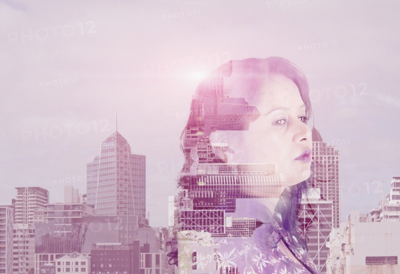 Double exposure of mixed race woman and cityscape