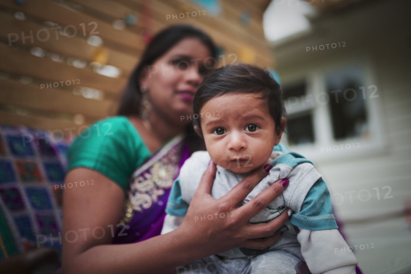 Indian woman holding baby son
