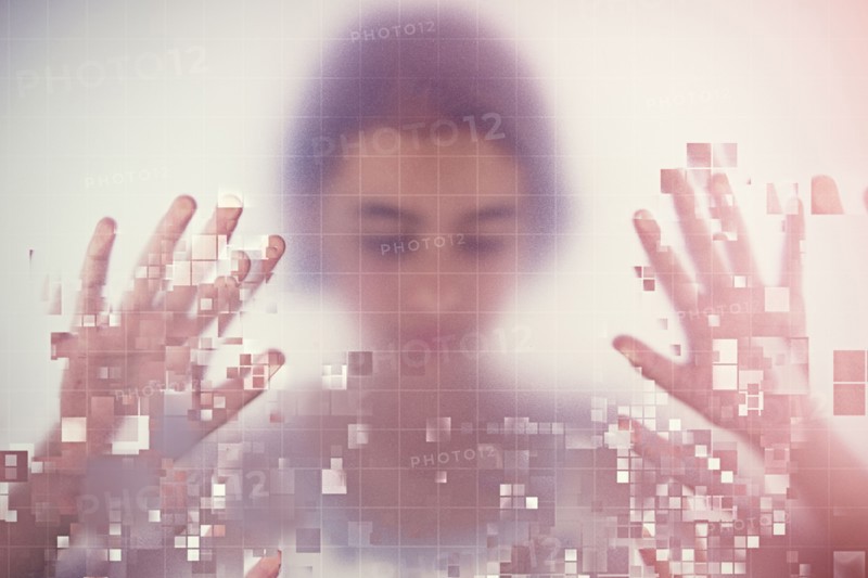 Mixed race girl standing behind pixelated screen