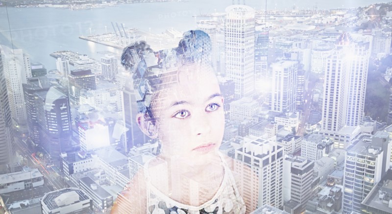 Double exposure of Mixed Race girl over urban waterfront