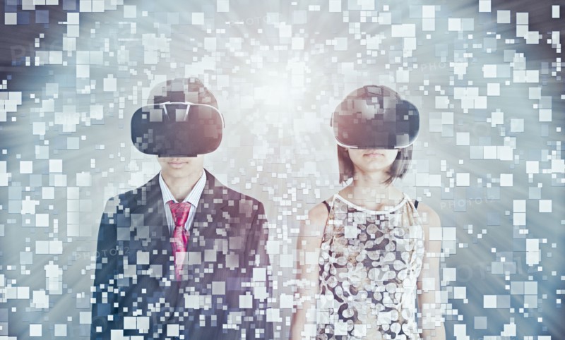 Mixed Race brother and sister using vr goggles
